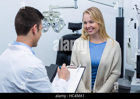 Optometrist consulting female patient Stock Photo