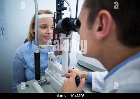 Optometrist examining female patient on slit lamp Stock Photo