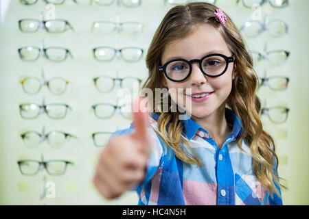 Portrait of a girl showing a thumbs up sign Stock Photo - Alamy