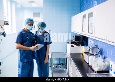 Surgeons discussing over digital tablet Stock Photo