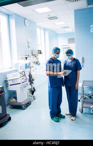 Surgeons discussing over digital tablet Stock Photo