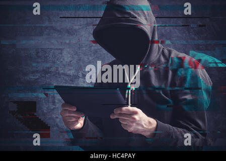 Cyber crime concept with digital glitch effect depicting faceless hooded person with digital tablet computer hacking online accounts Stock Photo