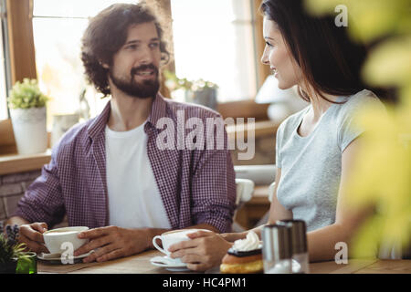 Couple interacting with each other while having coffee Stock Photo
