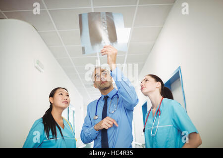 Doctor and nurses looking at x-ray Stock Photo