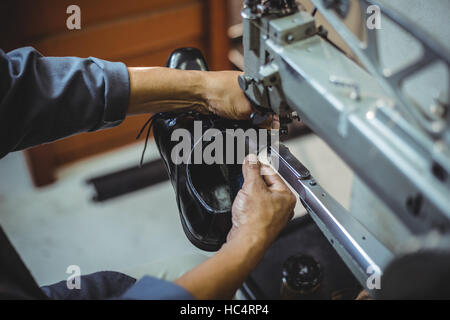 Shoemaker using sewing machine Stock Photo