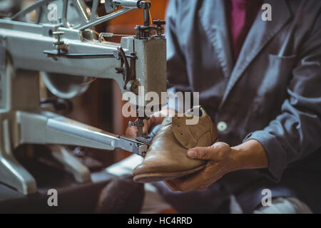 Shoemaker using sewing machine Stock Photo