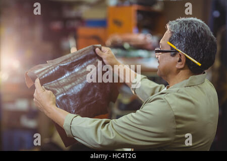 Shoemaker examining a piece of leather Stock Photo