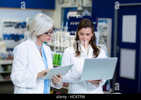 Pharmacists using digital tablet and laptop Stock Photo