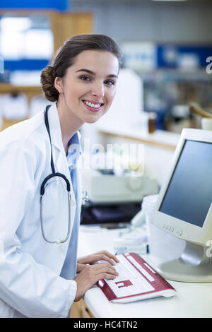 Pharmacist working on computer in pharmacy Stock Photo