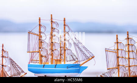 A model of sailboat over water in background. Stock Photo
