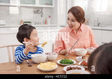 Loving mother and son having meals Stock Photo