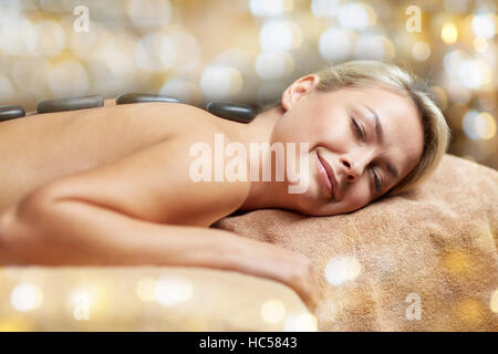 close up of woman having hot stone massage in spa Stock Photo