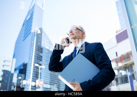 senior businessman calling on smartphone in city Stock Photo