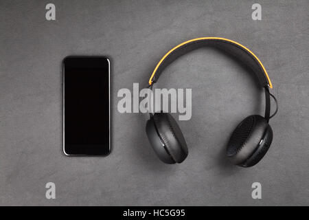 Black modern smartphone and headphones Stock Photo