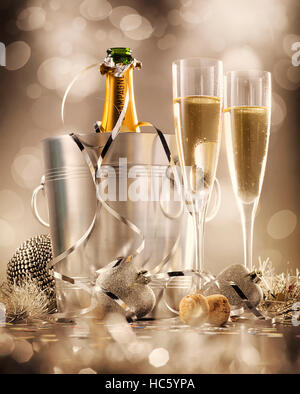 Two glasses of champagne with bottle in cooler in the background, selective focus Stock Photo