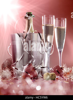 glasses of champagne with bottle in cooler on a red with white background Stock Photo