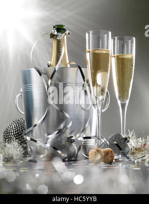 Two glasses of champagne with bottle in cooler on a silver background, selective focus Stock Photo