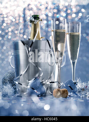 dim light white silver and blue romantic new year eve or christmas table in a luxury restaurant with champagne Stock Photo