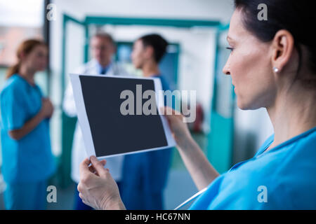 Surgeon examining a report Stock Photo