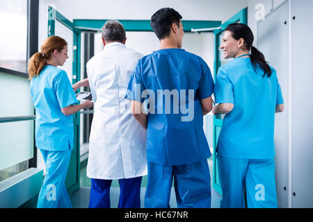 Rear view of doctor and surgeons interacting with each other Stock Photo