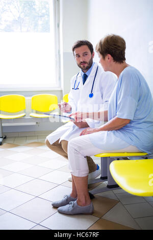 Doctor consulting patient in waiting room Stock Photo