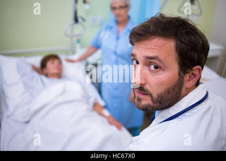 Portrait of doctor standing in hospital room Stock Photo