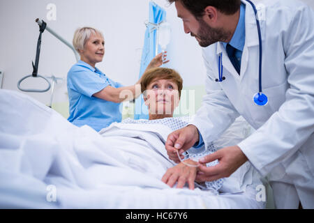 Doctor attaching iv drip on patient s hand Stock Photo