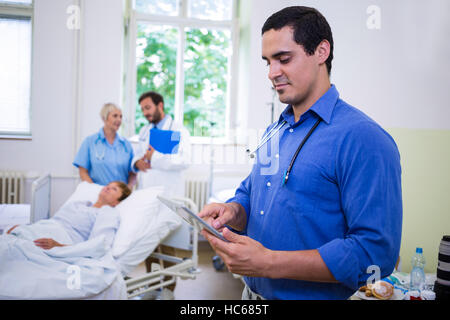 Confident doctor using digital tablet Stock Photo