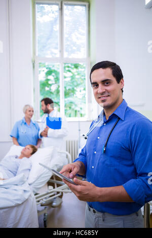 Confident doctor using digital tablet Stock Photo