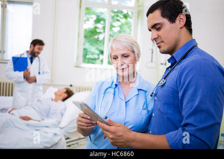 Doctor and nurse using digital tablet Stock Photo