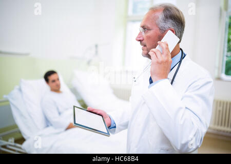 Doctor talking on mobile phone Stock Photo