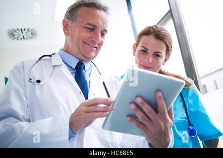 Doctor and nurse discussing over digital tablet Stock Photo