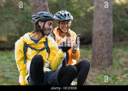 Biker couple using mobile phone Stock Photo