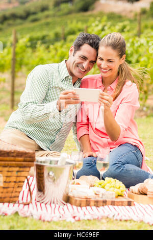 Happy couple using mobile phone Stock Photo