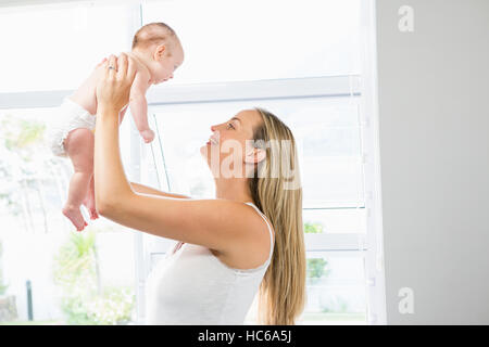 Mother playing with her baby in living room Stock Photo