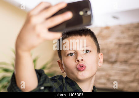 Funny Boy Taking Comic Selfie with Weird Expression Stock Photo