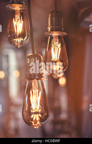 Old Style Glowing Light Bulbs Hanging in Bar Stock Photo