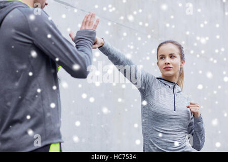 woman with coach working out strike outdoors Stock Photo