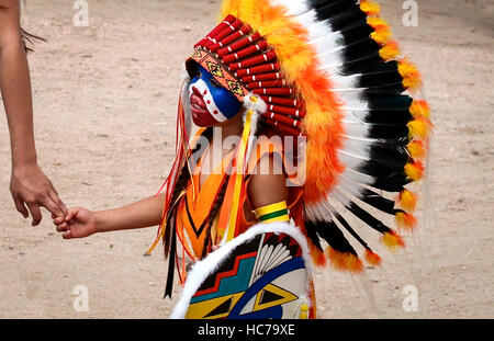 Ohkay Owingeh Pueblo, New Mexico, United States.  Summer Feast Day Celebration.  Tewa tribe. Mother assisting son. Stock Photo