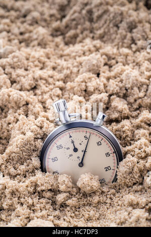 Chronometer half-buried in the sand Stock Photo