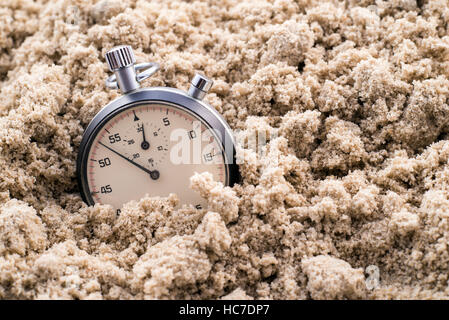 Chronometer half-buried in the sand Stock Photo