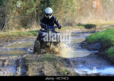 Quad biking on a dirty track, English farmland, UK Stock Photo