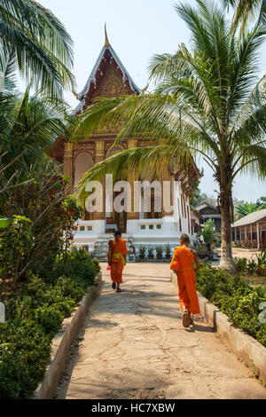 Two monks on the gorunds of Wat Siphoutthabath, Mount Phousi, Luang Prabang, Laos. Stock Photo