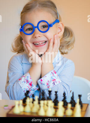 Portrait of beautiful little girl with chess Stock Photo