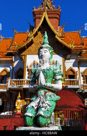 Praying statue in front of the ordination hall at Wat Buppharam Temple in Chiang Mai, Thailand Stock Photo