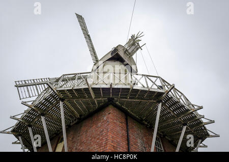 A white smock mill built in 1869 onto a two storey red brick base with attached miller’s cottage, Stock Photo