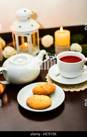 Cookies on plate and cup of tea in cafe. Stock Photo
