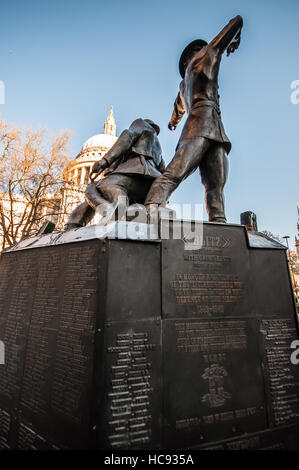 National Firefighters Memorial is a memorial composed of three bronze firefighters opposite St Paul's Cathedral Stock Photo