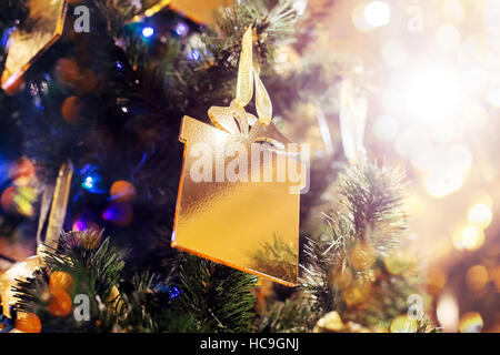Christmas and New Year glowing Background with Holiday Decoration. Gold of de-focused lights decorated tree Stock Photo