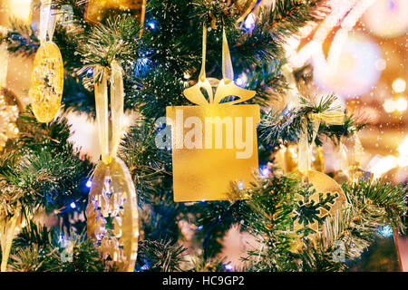 Christmas and New Year glowing Background with Holiday Decoration. Gold   of de-focused lights  decorated tree Stock Photo